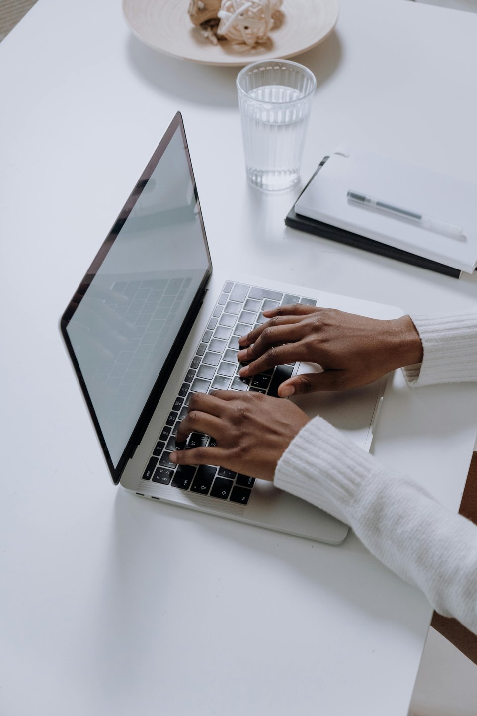Image of a person typing on a computer (no face shown)