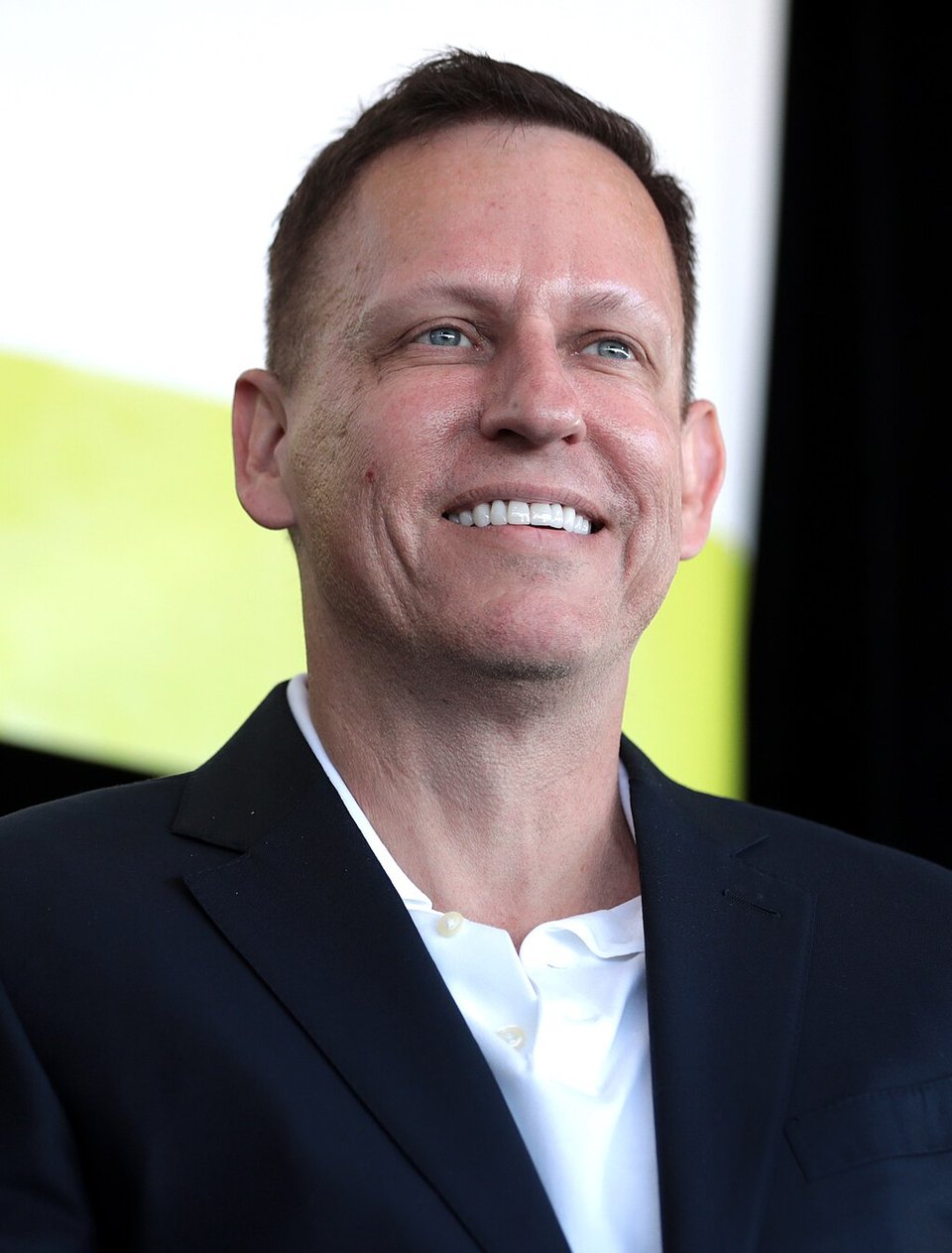 Peter Thiel smiling and looking at something out of frame. Image credit: Gage Skidmore.