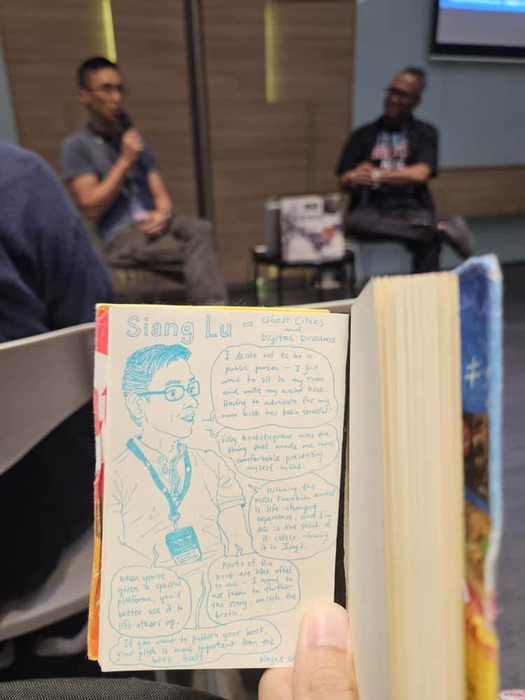 A sketch of Siang Lu, paired with numerous speech bubbles capturing what he was saying during his panel. In the background, you can see Siang and myself chatting.