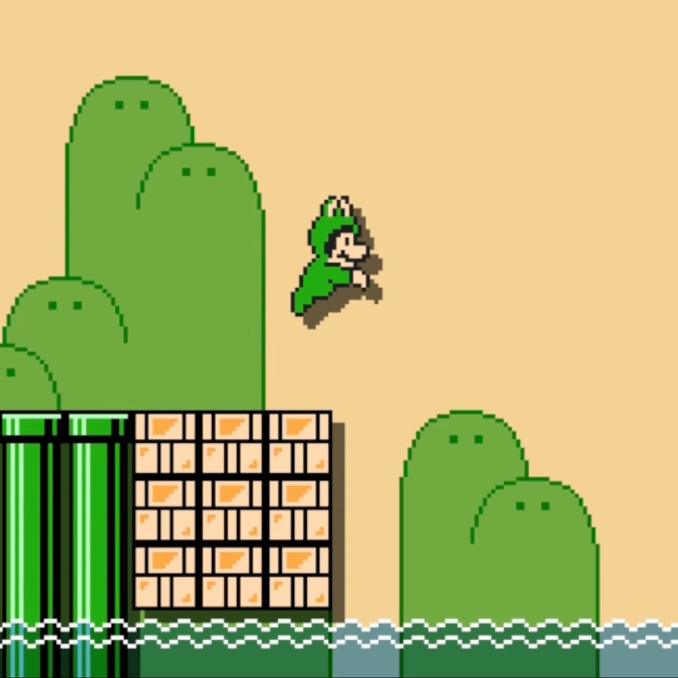 A screen shot of Mario in a frog suit jumping from a platform into some water