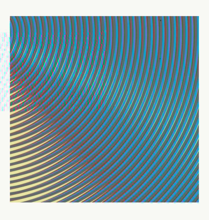 detail of an overlapping pattern of blue, red, and yellow curved concentric stripes