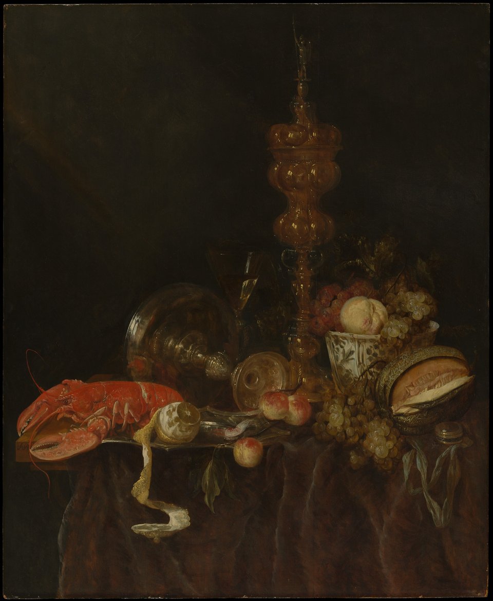 A still life composition featuring a vibrant red lobster, an elegant glass goblet, an assortment of fruits, and various decorative objects arranged on a dark, textured surface.