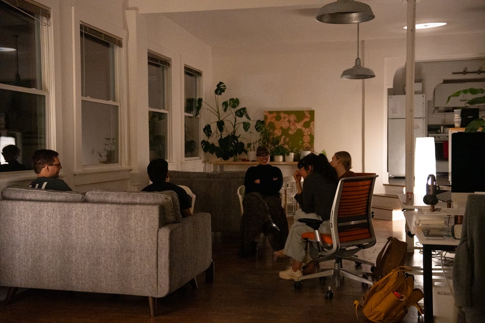 A group gathered at couches and chairs.
