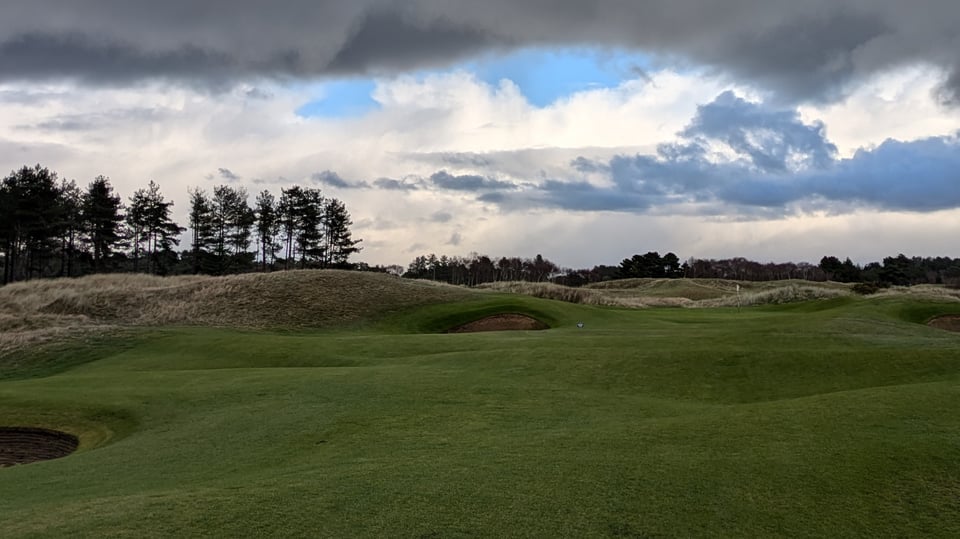 Formby 13th from the undulating fairway protecting a small green with a ball just past the pin