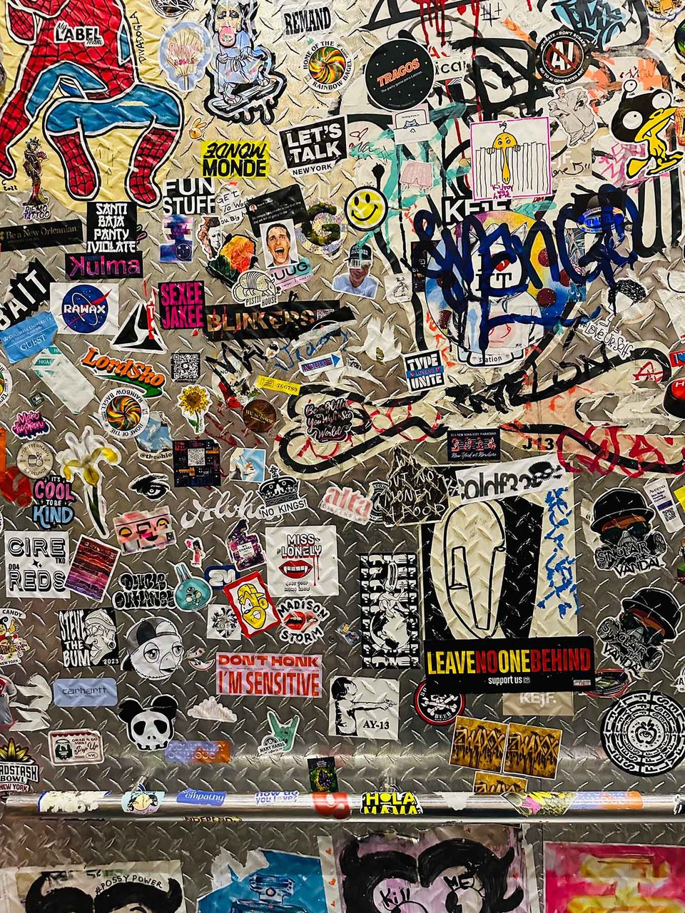 A NYC elevator with a billion bumper stickers.