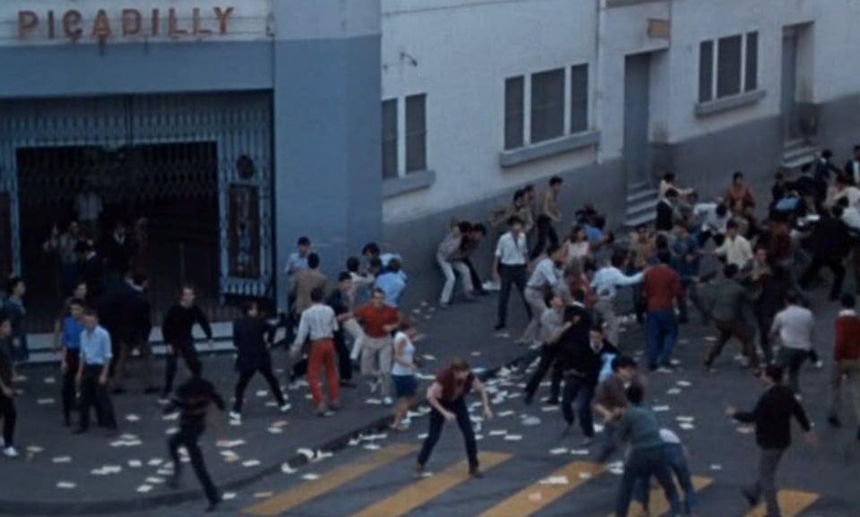 still frame from the movie Z showing a riot outside a closed theater