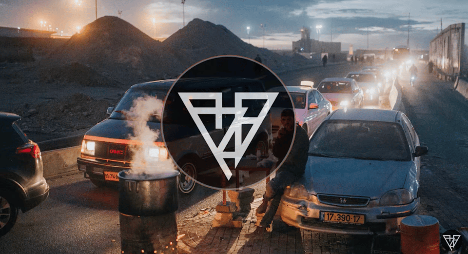 Cars lined up in traffic, and a logo in a circle