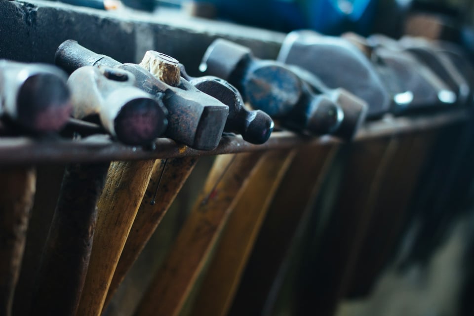 A row of hammers. Photo by Adam Sherez on Unsplash.