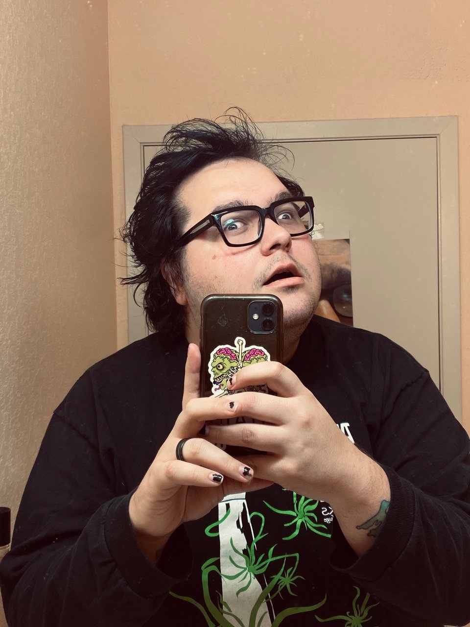 gender-confused person/creature with black hair staring very confidently at the camera