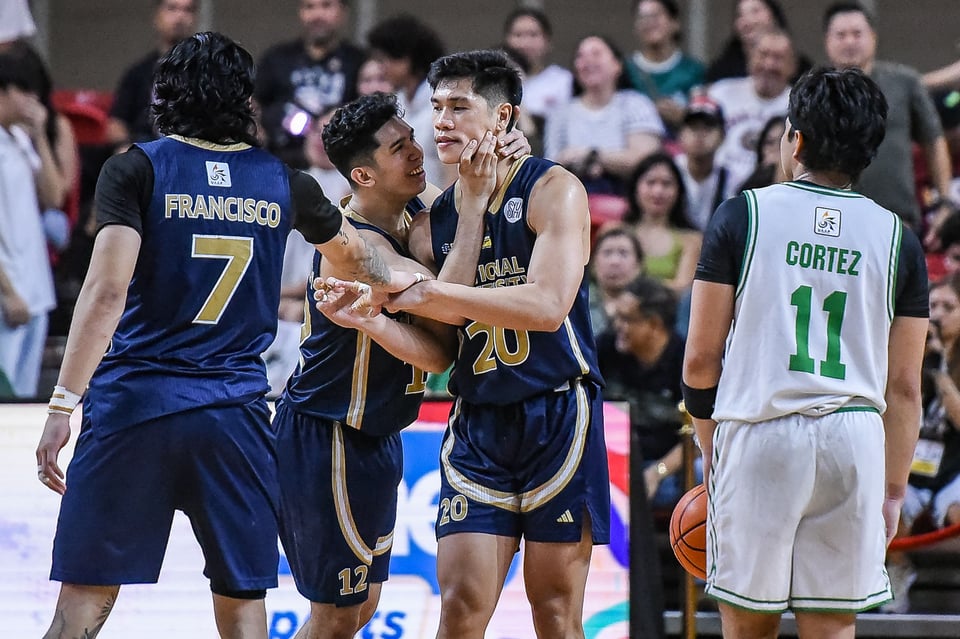 one filipino basketball player squeezes the face of another