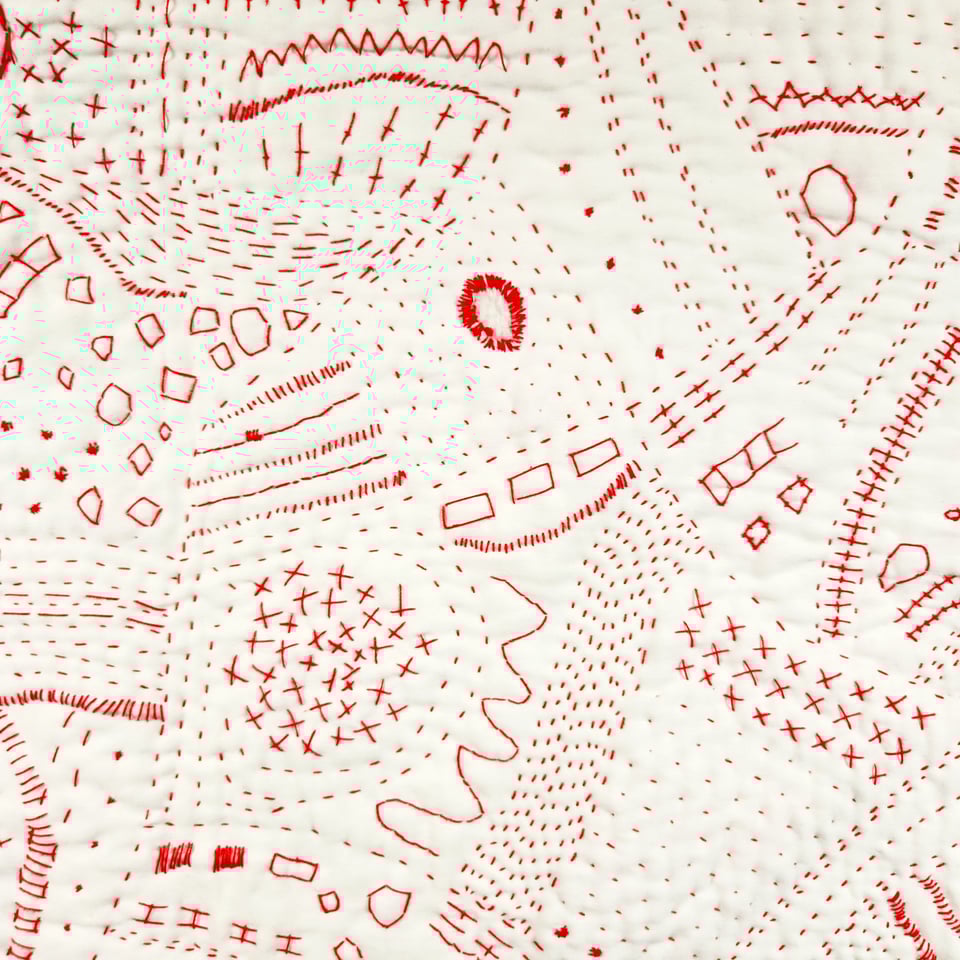 Detail of Red Map, a hand stitched quilt by Sarah Atlee. Red thread on white pillowcase, 2025.