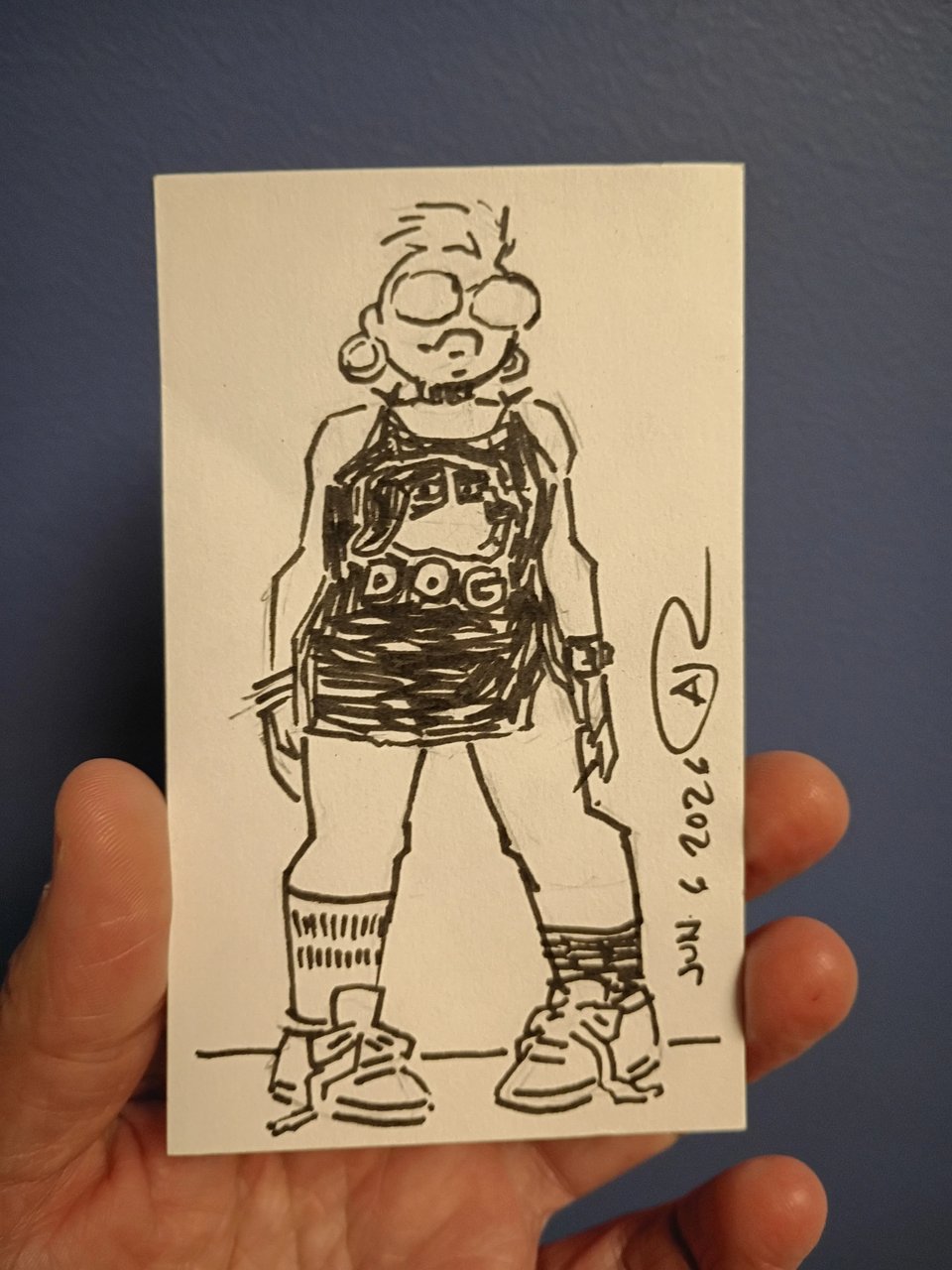 Drawing of Val in ink, wearing a chopped up t-shirt as a dress, mismatched socks, and sneakers.