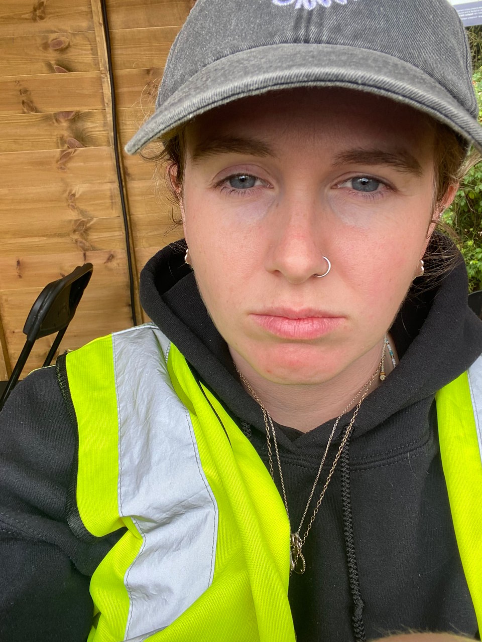 a woman wearing a safety vest and a hat
