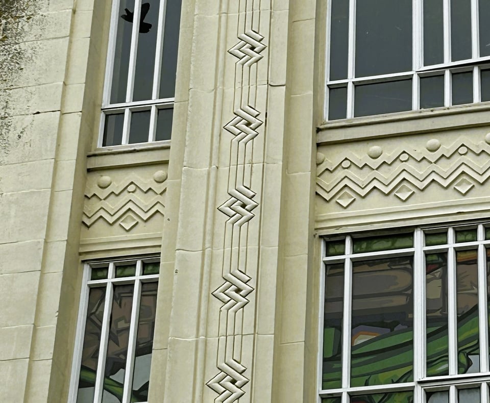 Close up of some of the decorative patterns around the windows. This includes a zigzag cable pattern on the vertical frame, and zigzags with dots and diamonds on the horizonal.