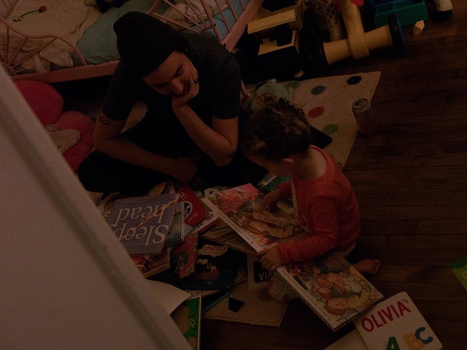 Sona and Alex going through a pile of books