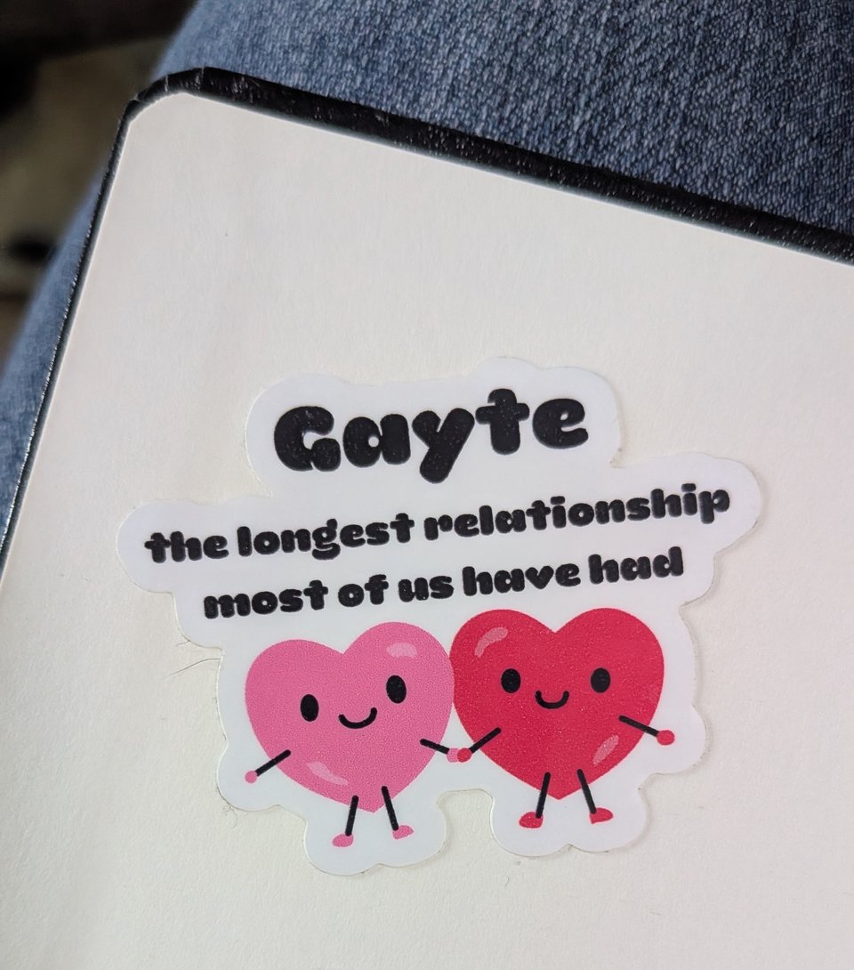 A sticker of two hearts holding hands with the caption "Gayte: the longest relationship most of us have had"
