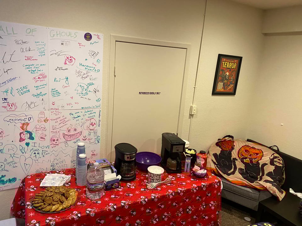 Holiday table with cookies and coffee pots on the surface.