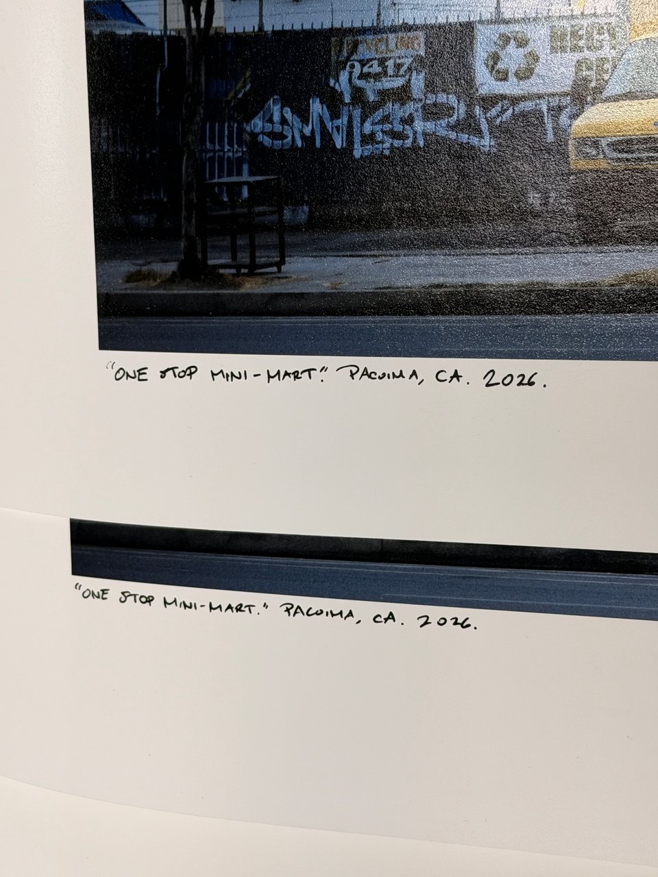 A close-up of my handwritten title, location, and year for the two prints of my "One Stop Mini-Mart" artwork. The text reads: "One Stop Mini-Mart. Pacoima, CA. 2026."