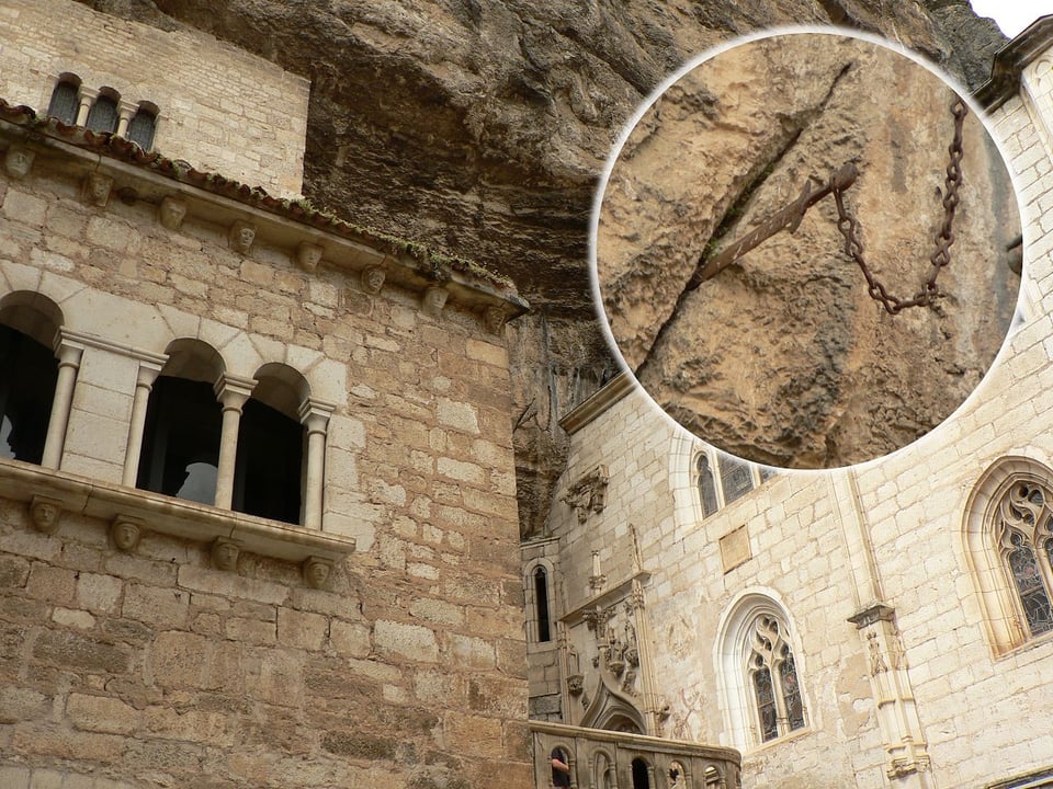 An old rusted sword jammed into a cliff face.