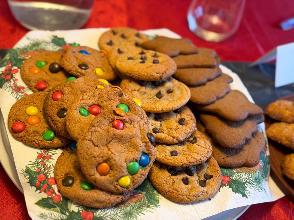 A plate piled with three different types of cookies