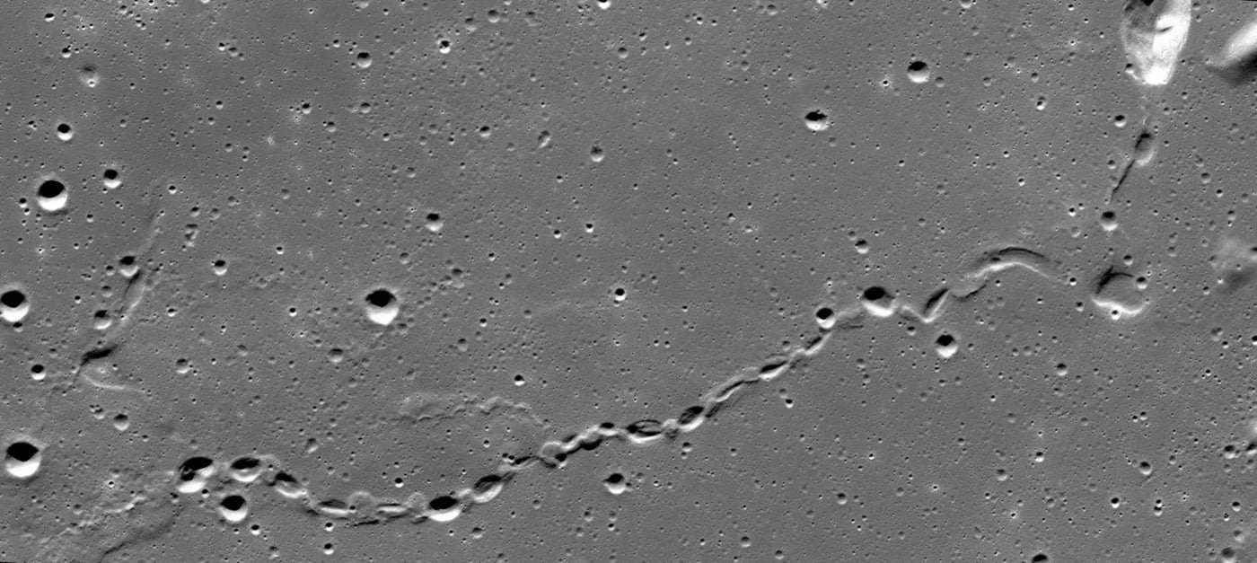 Sinuous 50 km long chain of collapse pits transitions into a continuous uncollapsed segment of a lunar lava tube, near Gruithuisen. From Wikipedia.