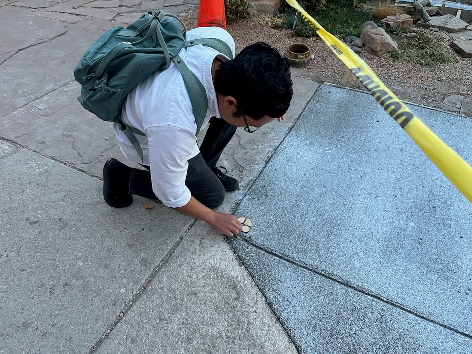 A hooligan attempts to vandalize not-so-freshly-poured concrete.