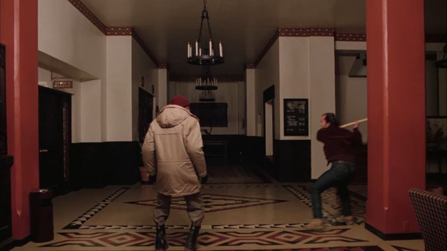 Hallorann stands in the Hotel’s foyer (I think), startled as Jack emerges from behind a column swinging his axe.