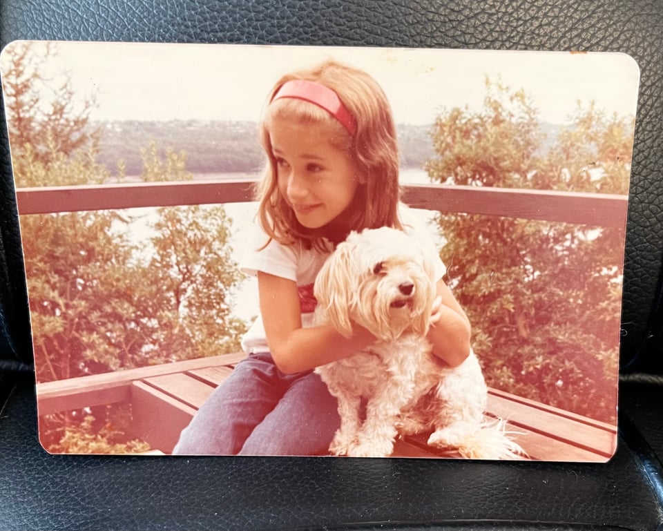 Me as a kid with a fluffy white dog sitting on the deck of the Gig Harbor house overlooking the Narrows.