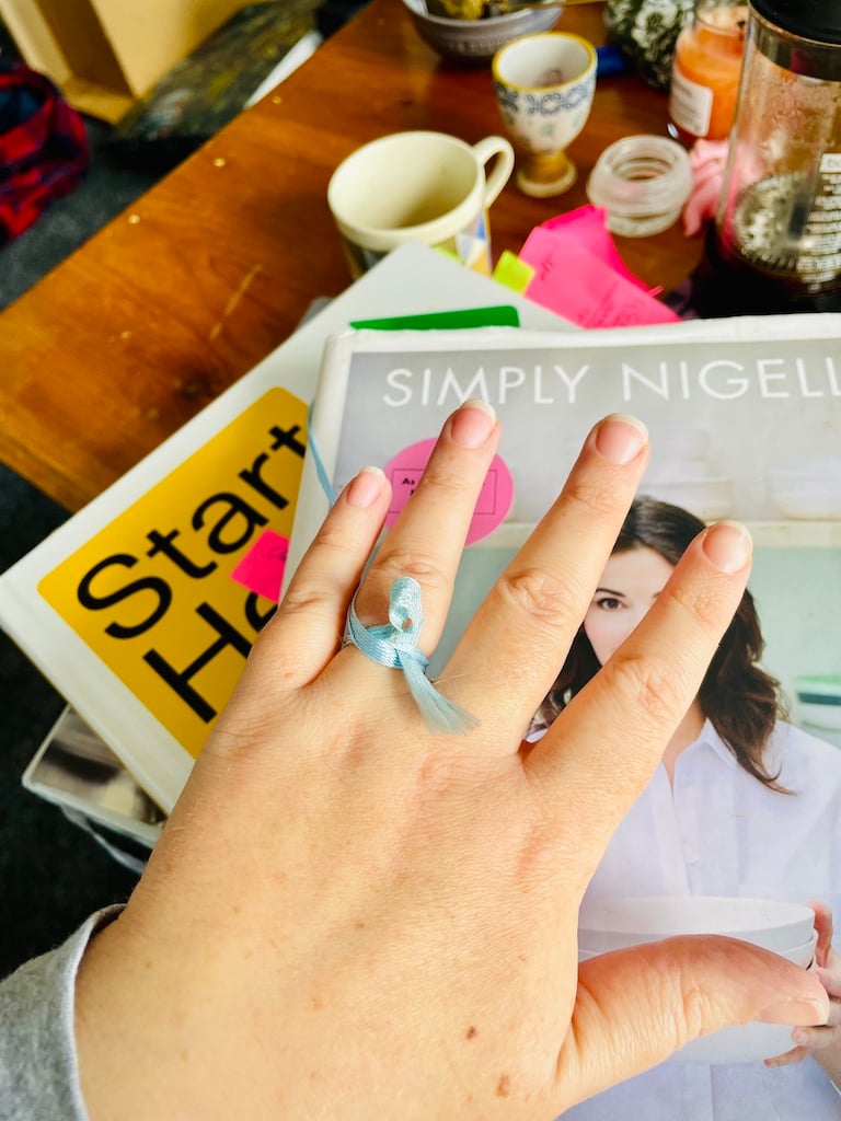 A hand in the newly engaged pose, with Nigella and Sohla books below