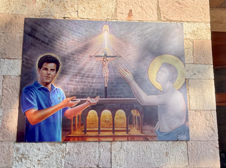 A somewhat cheesy image of Carlo in a polo shirt beside St. Francis in his naked before the lord moment