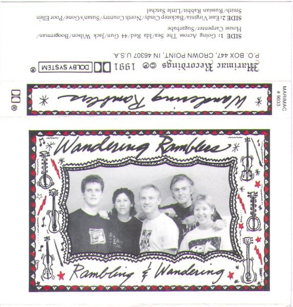 Tape sleeve - the name, written in script above a photograph of three men and two women looking into the camera, is Wandering Ramblers. At the bottom is the title "Rambling & Wandering". The cover is illustrated in black and red, with drawings of instruments, stars and lightning bolts