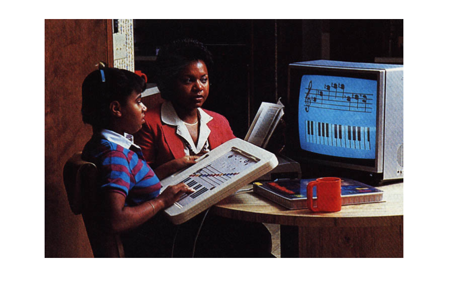 A student and teacher using the PowerPad to practice reading and creating music