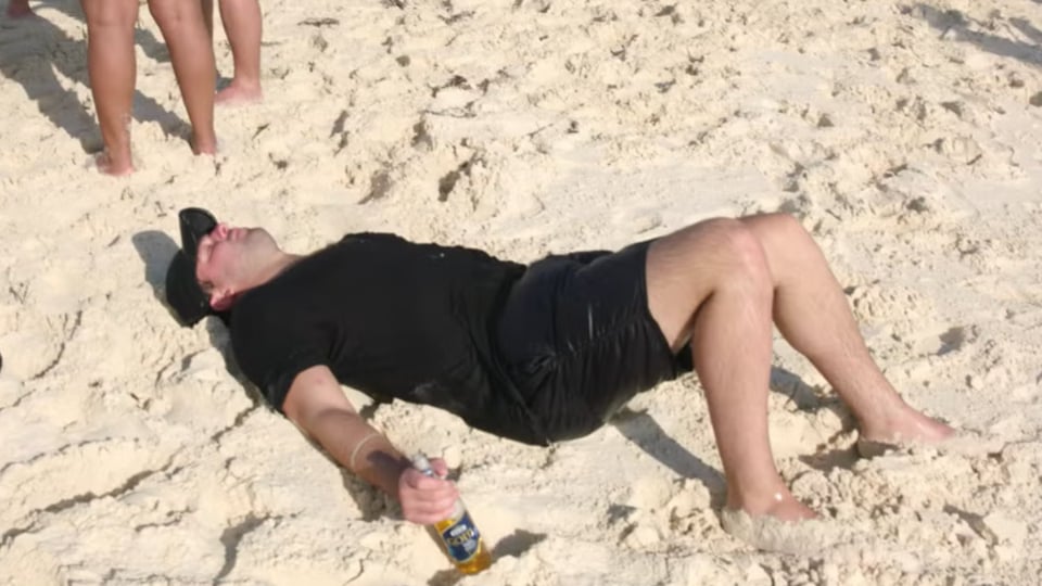 Man laying in sand