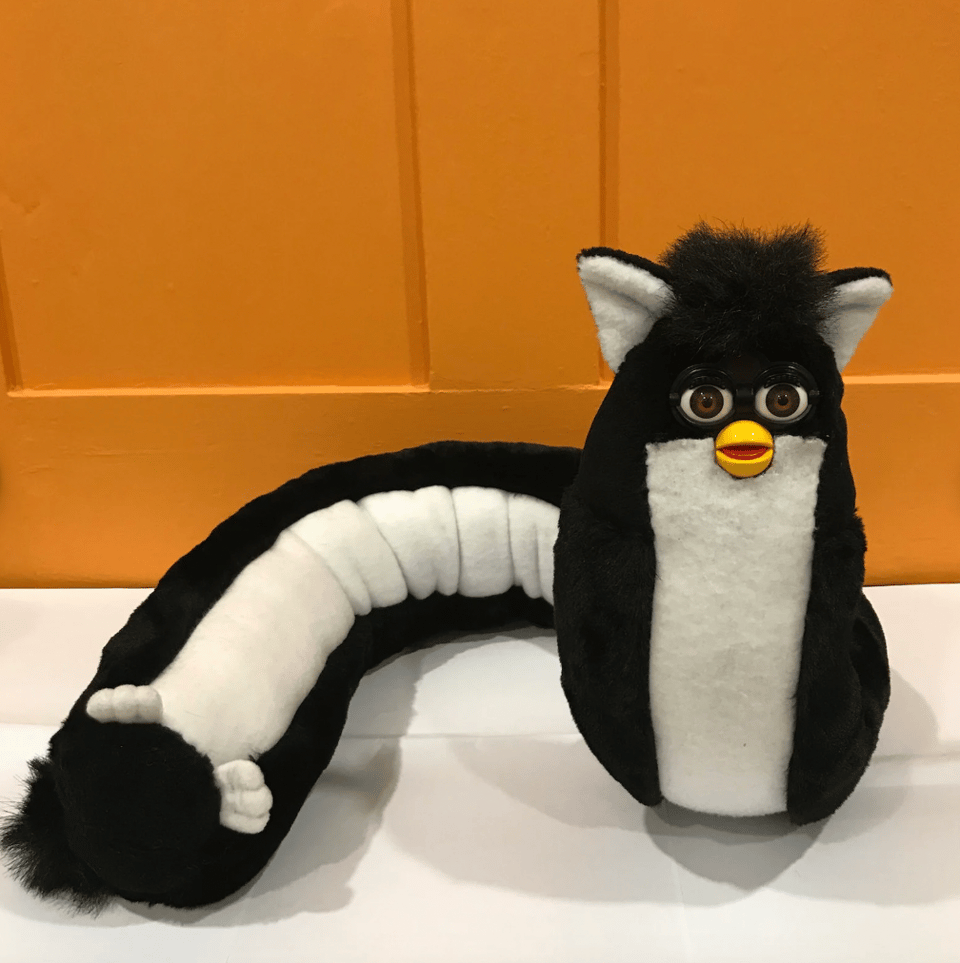 A Furby with an elongated body