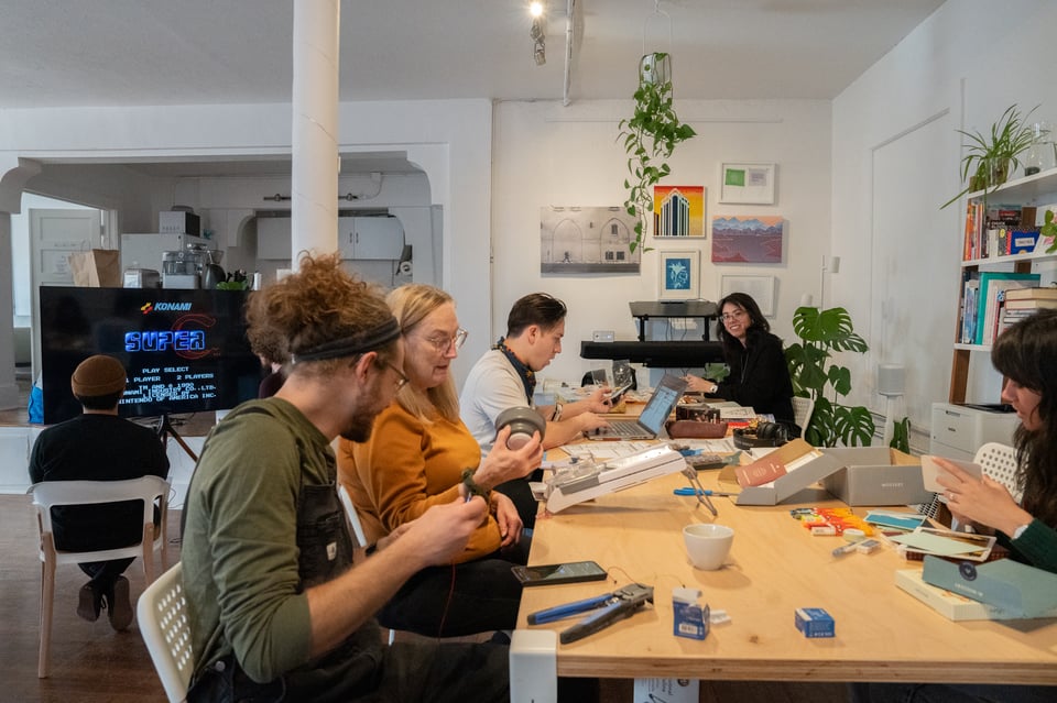 A group around a table playing with toys.