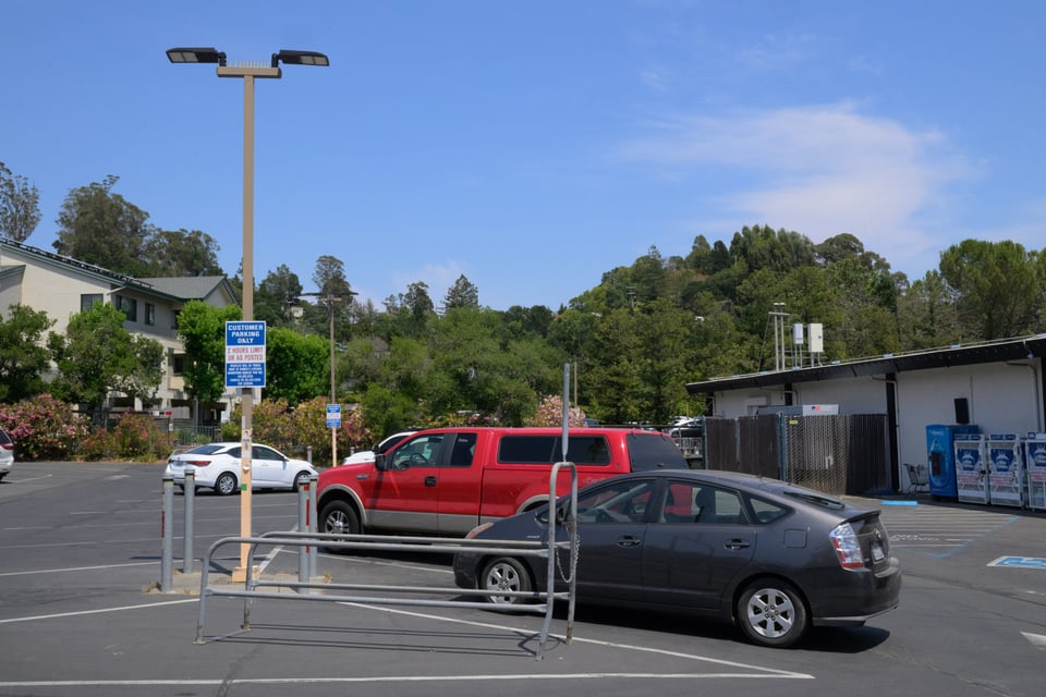 Photo of a grocery store parking lot at midday.