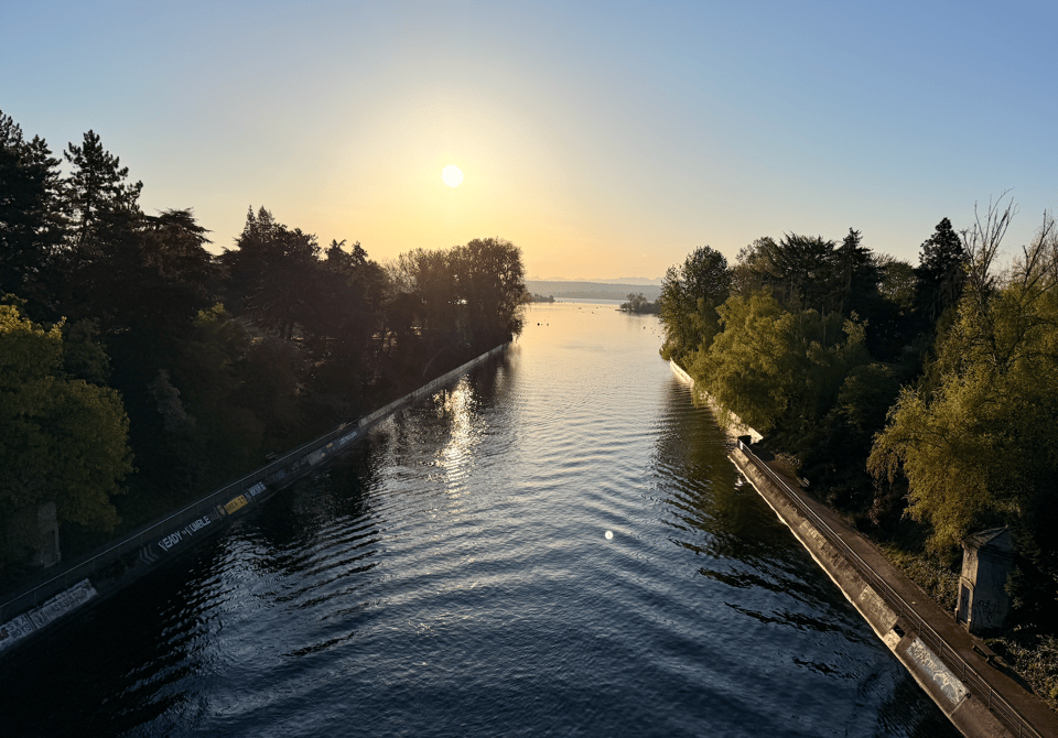 The sun over the Montlake Cut, with placid waters and no people in the shot.