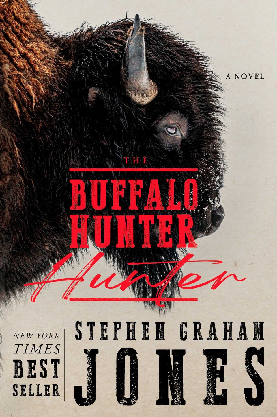 Cover of the novel The Buffalo Hunter Hunter, by Stephen Graham Jones, depicting a seasoned bison with golden and black fur looking at the viewer sidelong with snow dusting their muzzle; other text notes that Jones is a New York Times bestselling author of The Only Good Indians