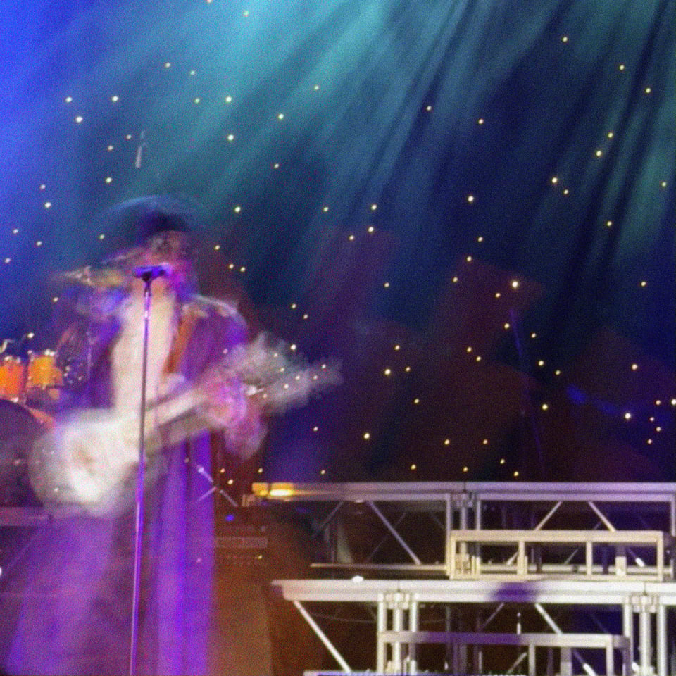 a blurry picture of Purple Reign, the world's #1 tribute to Prince