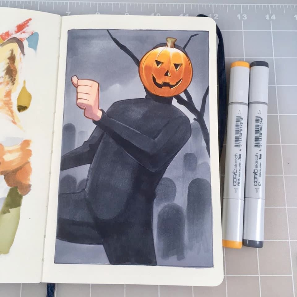 A sketchbook showing a picture of a man in a skintight black bodysuit wearing a pumpkin mask