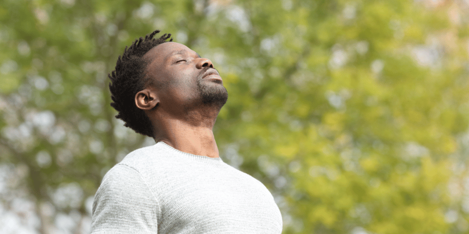 A man breathing in.