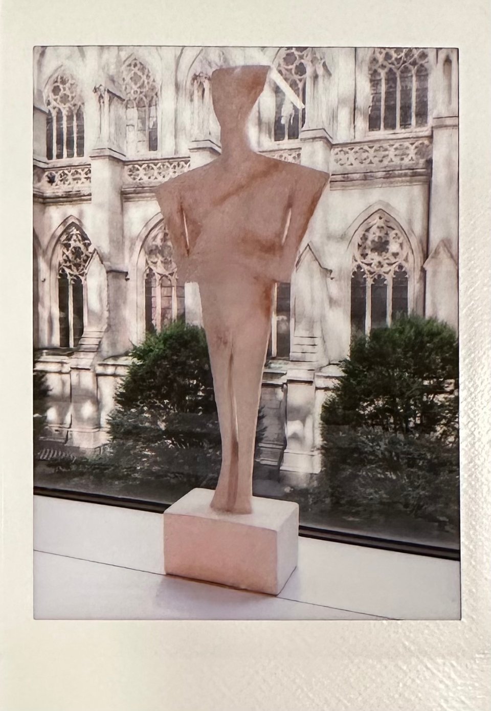 photo of a statuette on a windowsill; St. Patrick's Cathedral is in the background