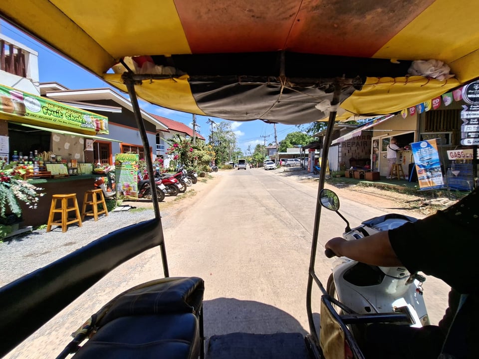 A view from the seat of a tuktuk on the main road her in Koh Lanta
