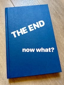 hardcover book with words THE END NOW WHAT? on cover.