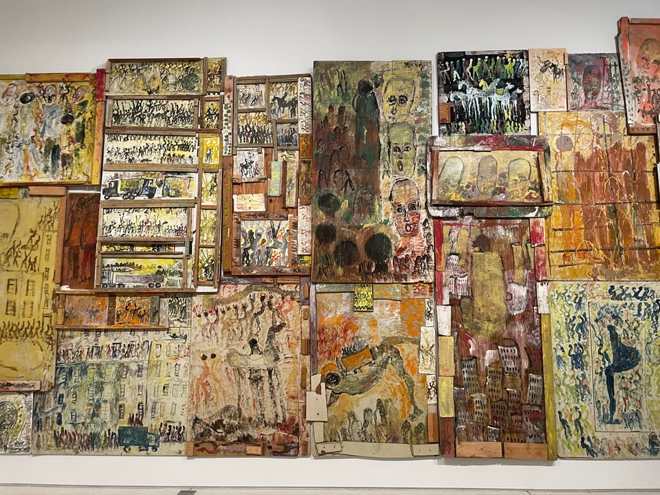 a solid wall of art from found materials and house paint