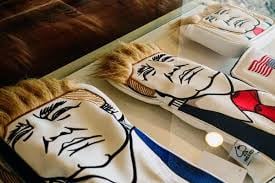 Golf club covers with the likeness of narcissistic Trump for sale at the pro shop at Trump National Doral, a golf resort near Miami.