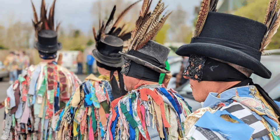 Some men in crazy rag and feather costumes.