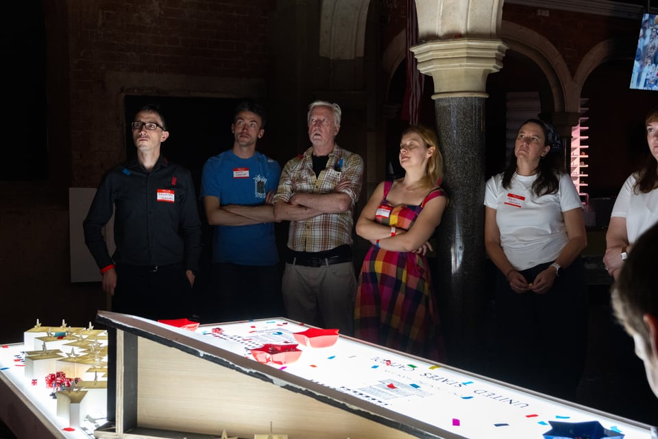 Players watch extensive footage of Jan. 6 at the conclusion of “Fight for America.” Peter van Agtmael/Magnum Photos for The Washington Post