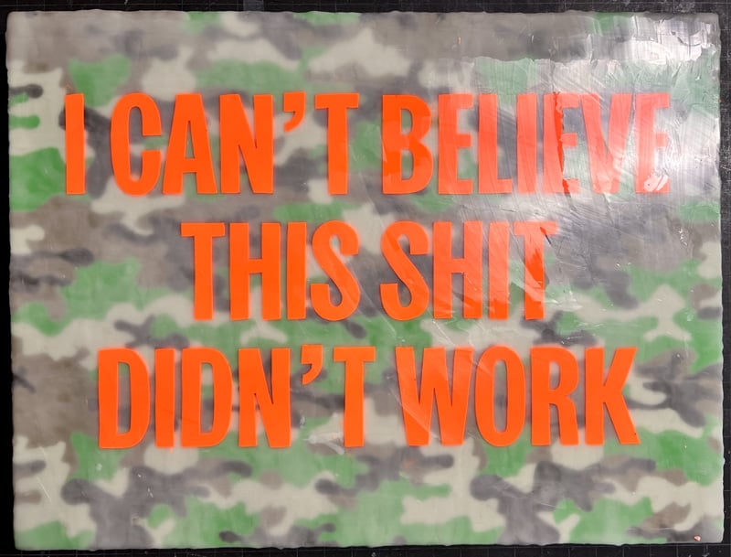 Camo background pattern with the text I CAN'T BELIEVE THIS SHIT DIDN'T WORK over it.