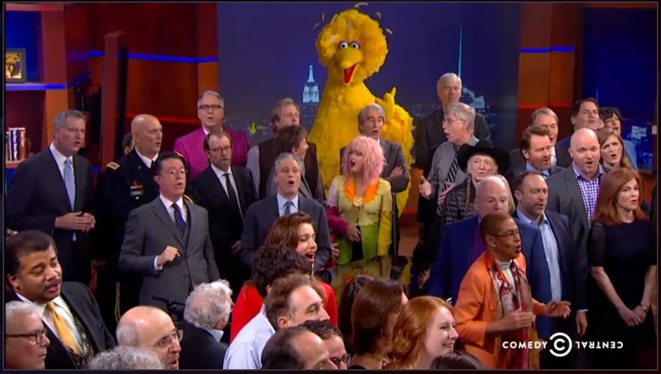 Stephen Colbert, singing with dozens of guests